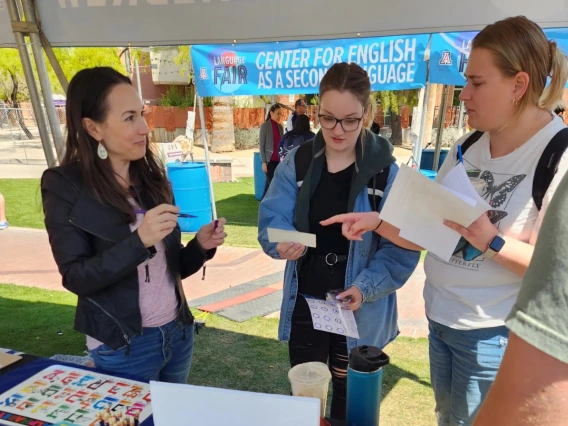 Students and staff interacting at an outdoor event.